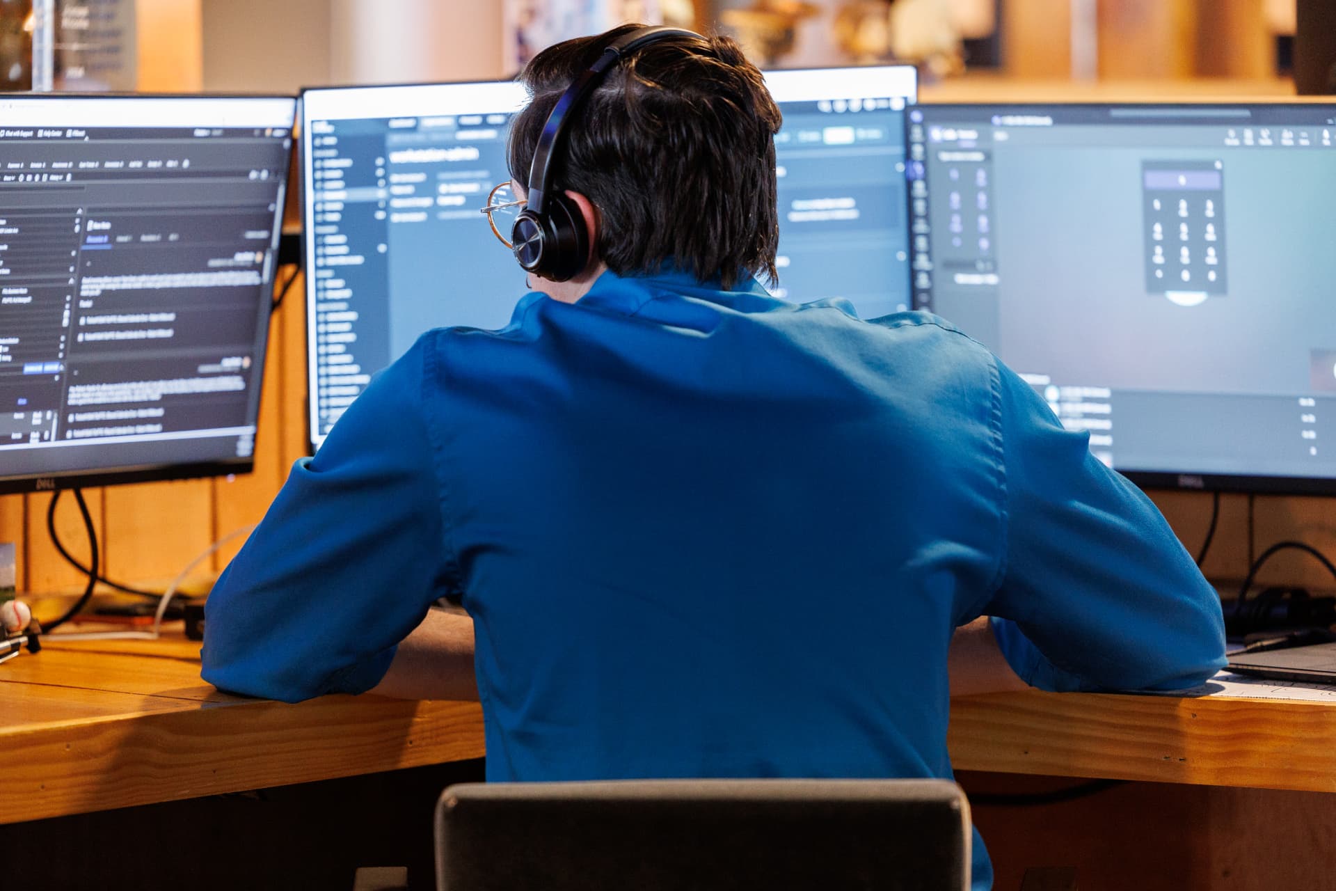 Engineer working alongside an internal IT lead at a multi-monitor workstation