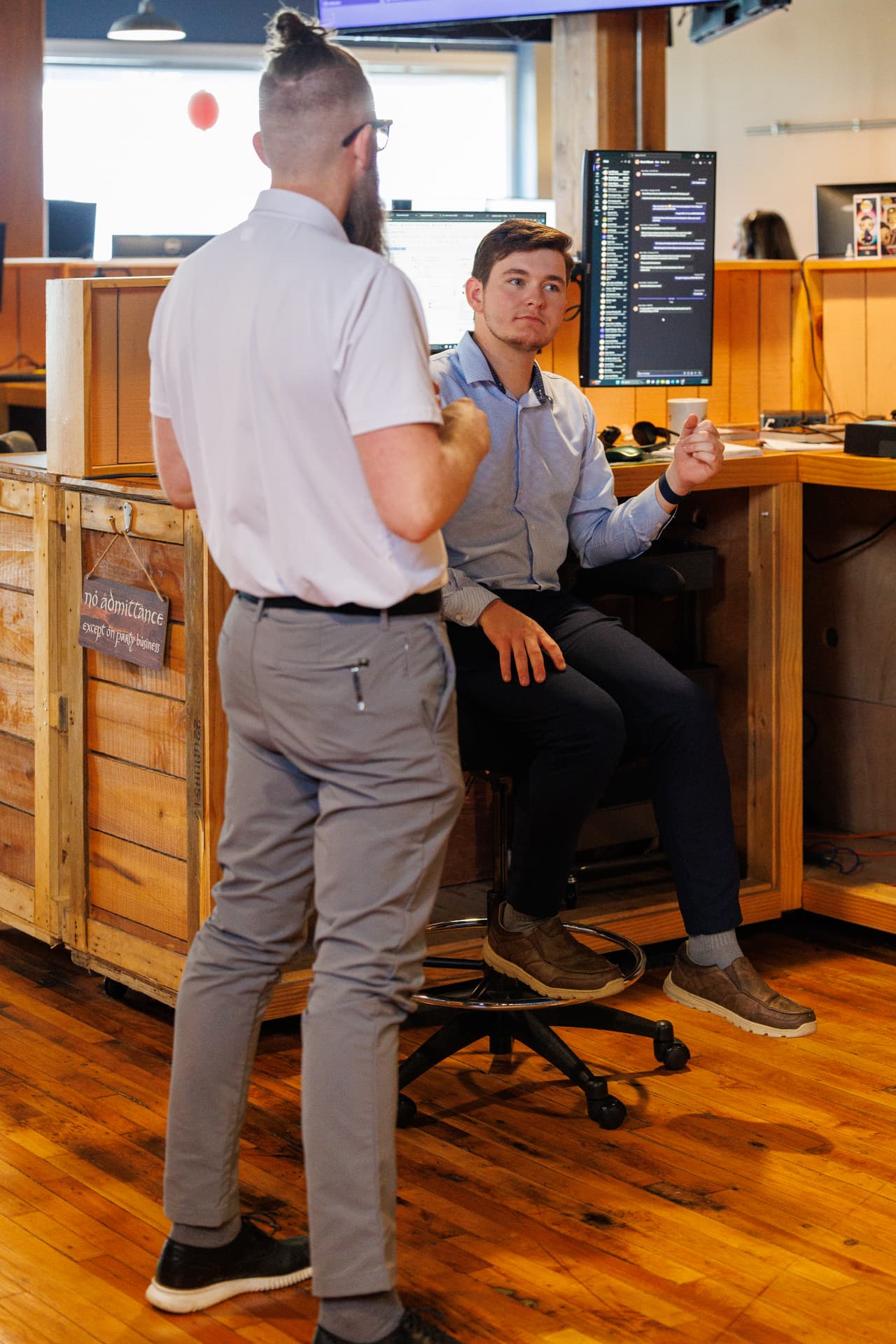Two team members in a joint project planning conversation at a workstation